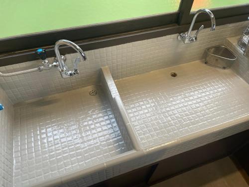 a bathroom sink with two faucets and a sink at SEA&SEE KOSE in Kose