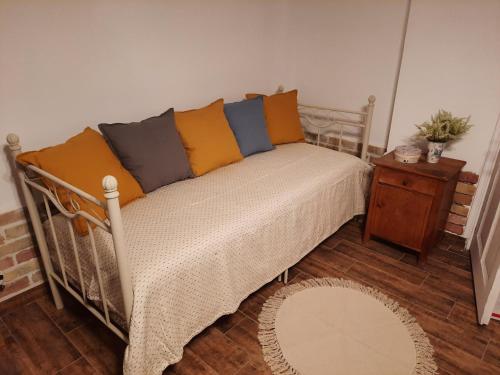 a bed with colorful pillows on it in a room at Kúria Apartman Budapest with free parking in Budapest