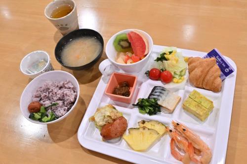 a plate of food with different foods on a table at Iriomotejima-Jungle Hotel Painumaya in Iriomote