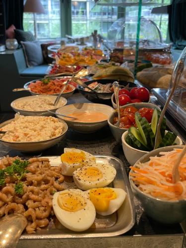a buffet of food with eggs and other foods at Hotel Villa Verdi in Knokke-Heist