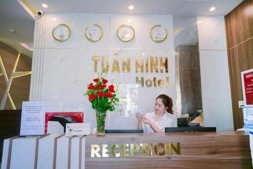 a woman standing behind a counter in a hotel at Tuấn Ninh Hotel I in Con Dao