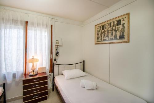 a bedroom with two beds and a window at Solomon House in Kritharia
