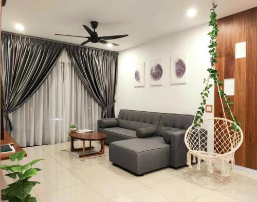 a living room with a couch and a ceiling fan at Ipoh Homestay - Manhattan Condominium with Water Park & Leisure Facilities in Ipoh