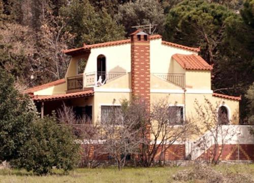 a large white house with a tower on top of it at Entire cottage near the beach in Nimporio, Euboea in Nimporio