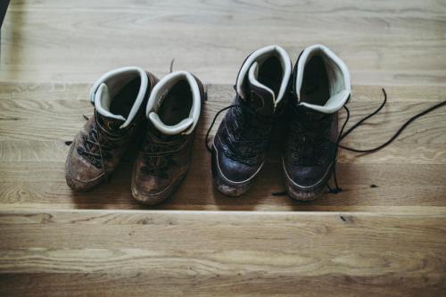 three pairs of shoes sitting on a wooden floor at Pflugwirts Hotel und Gasthaus in Oberkirch