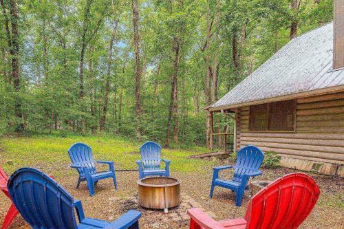 a group of blue chairs and a table in front of a cabin at Bald Eagle in Kingston Springs