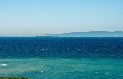 a large body of water with a ship in the distance at Splendide appartement calme et spacieux in Tangier