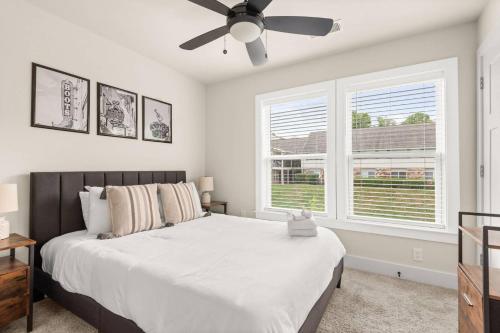 a bedroom with a large bed with a ceiling fan at Nashville Getaway in Nashville