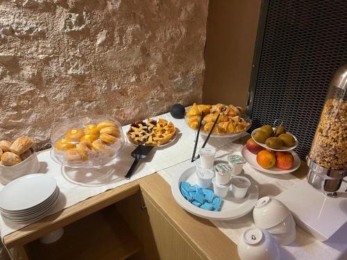 a table with several plates of food on a counter at Palazzo Fontana in Trevi