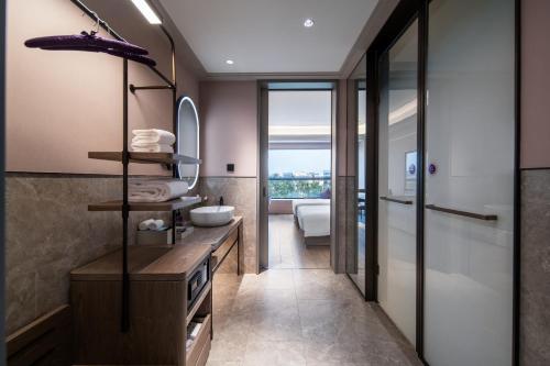 a bathroom with a sink and a mirror at Mercure Guangzhou Baiyun International Airport - Airport Free Shuttle Bus in Huadu