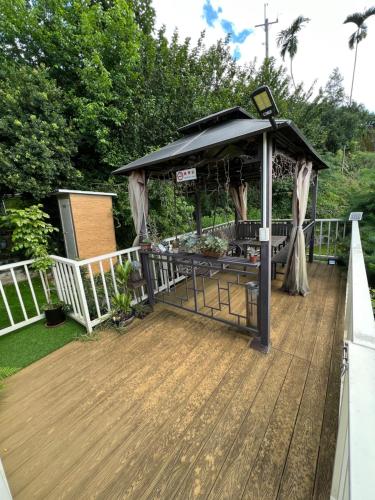 a gazebo on the deck of a house at Xiao Tang Villa in Dongshi