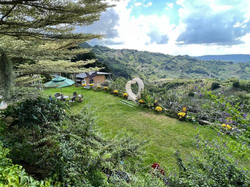 a grassy hillside with a house and a garden at Xiao Tang Villa in Dongshi