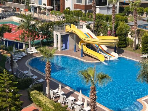 a slide in a pool at a resort at Penthouse 4 bedrooms, 1 living room, to the sea 7 minutes walk in Alanya