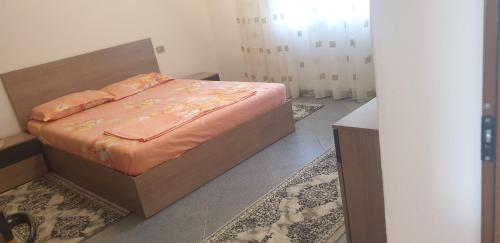 a bedroom with a bed in a room with rugs at Hills Villa in Vlorë