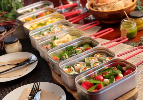 a table with several trays of food on it at GLAMDAY PORT in Atami