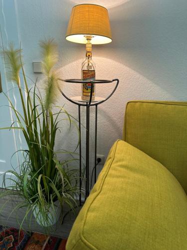 a lamp sitting on a table next to a couch at Remedium Appartements in Vlotho