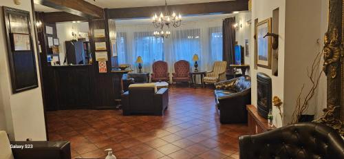 a living room with couches and a dining room at Vila Ralf in Cornu de Jos