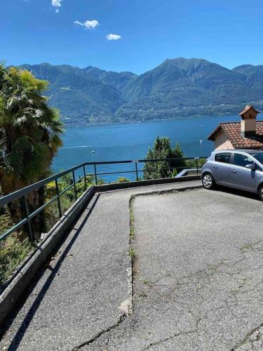 a car parked in a parking lot next to a body of water at Casa Verbanella in Minusio
