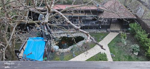 an overhead view of a house with a blue truck at Vila Ralf in Cornu de Jos