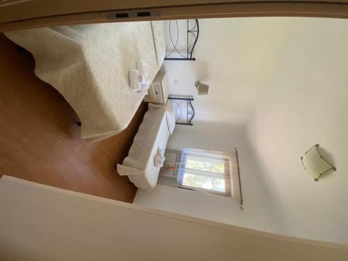 an attic room with a staircase and a window at Agriturismo I Tesori del Sud Vieste, Puglia in Vieste