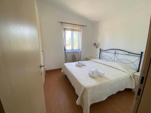 a bedroom with a bed with two towels on it at Agriturismo I Tesori del Sud Vieste, Puglia in Vieste