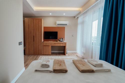 a bedroom with a bed with two pillows on it at Fortunella Suites in Finike