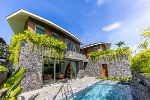 an exterior view of a house with a swimming pool at Bellerive Hoi An Resort and Spa in Hoi An