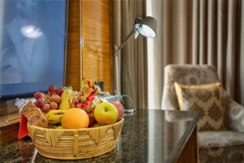 a basket of fruit on a table in a room at Marino Royal Hotel in Dhaka
