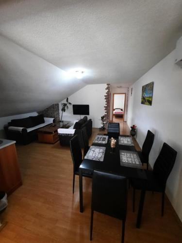 a living room with a table and chairs and a couch at Apartment Jonoski in Ohrid