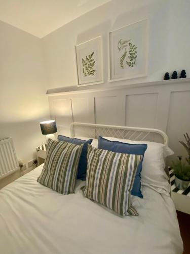 a white bed with two pillows on top of it at Lakeside View 2, Perton Village in Wolverhampton