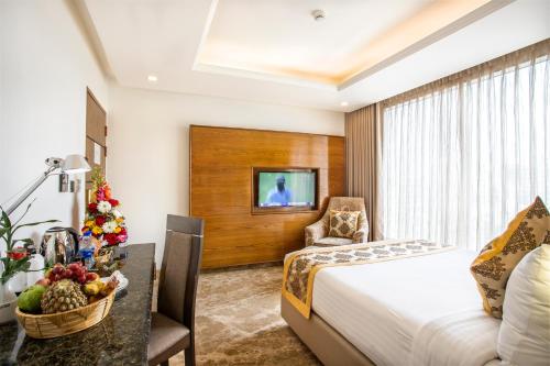 a hotel room with a bed and a table with a bowl of fruit at Marino Royal Hotel in Dhaka