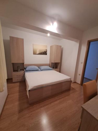 a bedroom with a large bed in a room at Apartments Ostojic in Tučepi