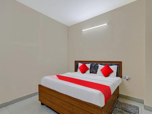 a bedroom with a large bed with red pillows at OYO Flagship 81216 Hotel Silver Grand in Lucknow