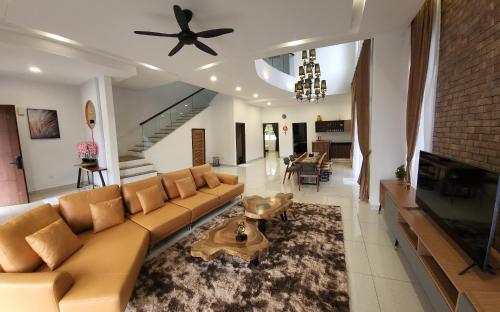 a living room with a couch and a fireplace at Zinnia Residences in Cameron Highlands