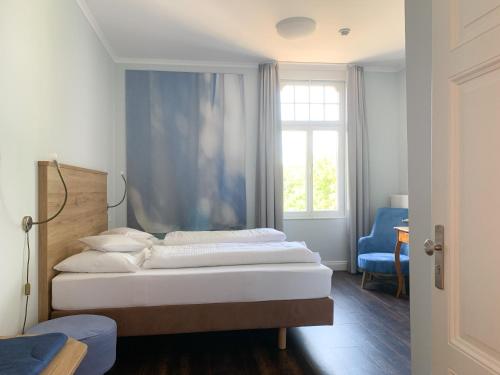 a bedroom with two beds and a window at 2T Hotel artgenossen in Lindlar