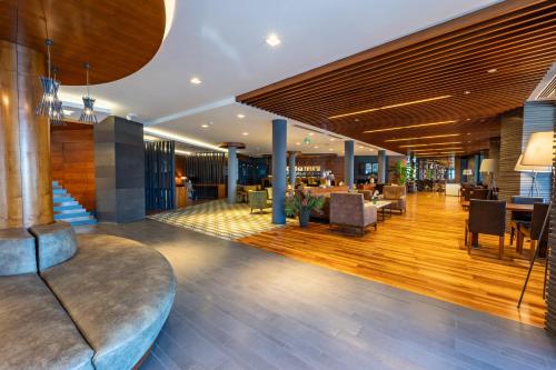 a lobby of a hotel with a couch and tables at Hotel Anatolia in Bursa