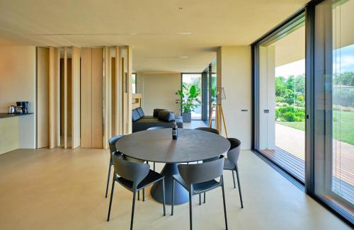 a dining room and living room with a table and chairs at VillasGarda - Villa Bardolino in Bardolino