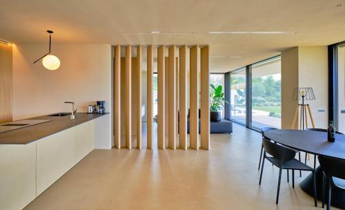 a kitchen and dining room with a table and chairs at VillasGarda - Villa Bardolino in Bardolino