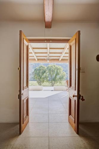 an open door to an empty room with a window at Somerset Gift Getaway Farm in Swellendam