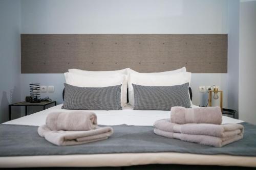 a bedroom with a bed with towels on it at Adriana's downtown studio-parking lot included in Patra