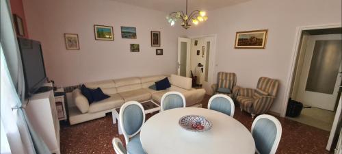 a living room with a couch and a table and chairs at Home Rome Center in Rome