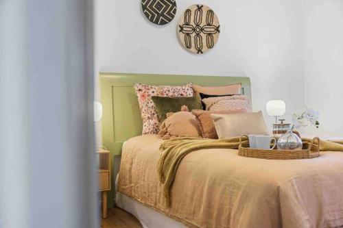 a bedroom with a bed with a green head board at Stunning 2BR CBD Apartment next to King's Park in Perth