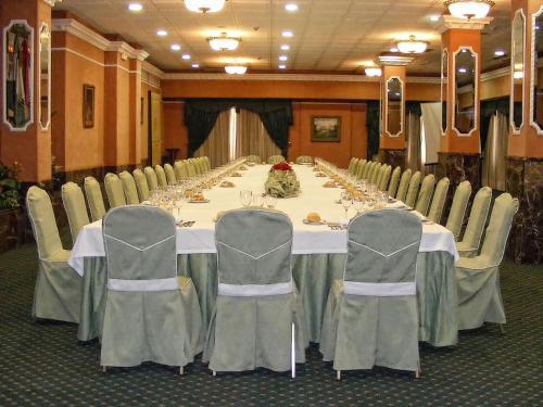 a long table in a conference room with chairs and a table at Infanta Cristina in Jaén