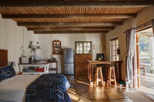a kitchen with a bed and a table in a room at Somerset Gift Getaway Farm in Swellendam