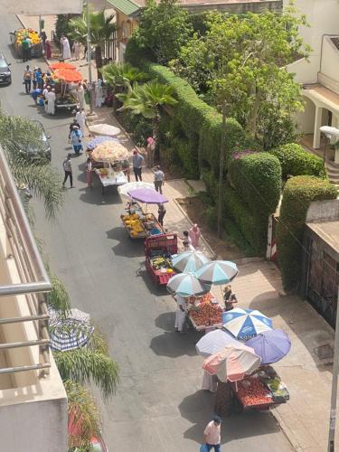 an overhead view of an outdoor market with umbrellas at Huge 4 bedroom Condo 2 min walking to TGV train in Kenitra