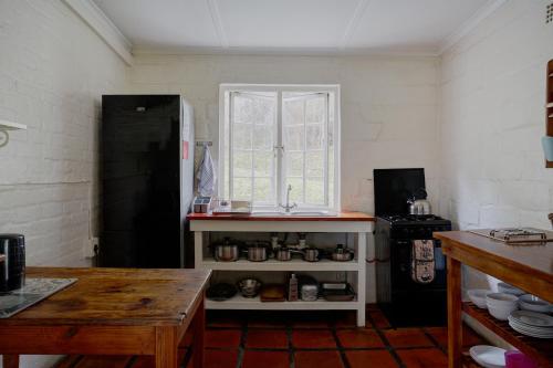 a kitchen with a sink and a window at Somerset Gift Getaway Farm in Swellendam