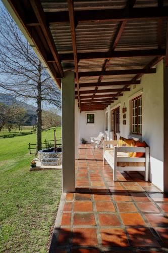 a porch of a house with a wooden roof at Somerset Gift Getaway Farm in Swellendam