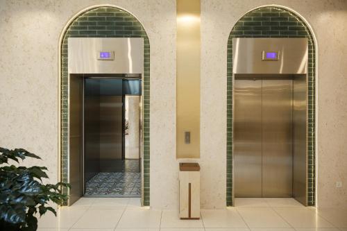 two elevators with their doors open in a building at Wellesley Hotel in Simpang Ampat