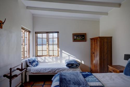 a bedroom with two beds and a window at Somerset Gift Getaway Farm in Swellendam