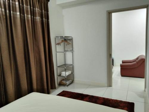 a bedroom with a bed and a closet with curtains at PINTARMAN EXPRESS @ MIRI TIMES SQUARE in Miri